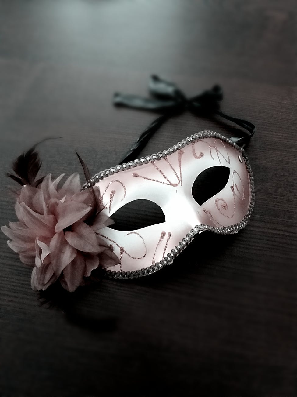 carnival mask decorated with pink flower